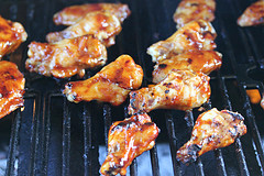 Honey bbq chicken wings grilling on barbecue
