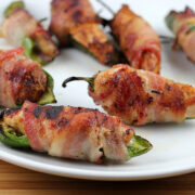 Cooked bacon wrapped jalapeno chicken bites on plate