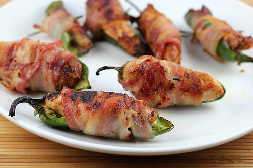 Cooked bacon wrapped jalapeno chicken bites on plate