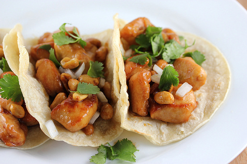 Kung pao chicken tacos on corn tortillas