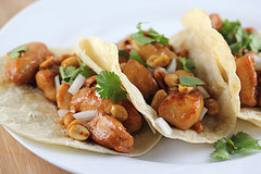 Kung pao chicken tacos with peanuts and cilantro