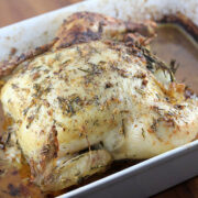 Lemon garlic roast chicken resting in a baking dish