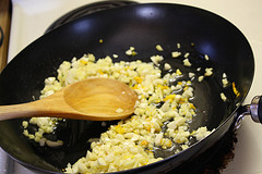 Chopped garlic sautéing in a skillet