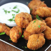 Crispy parmesan ranch chicken bites on a black plate