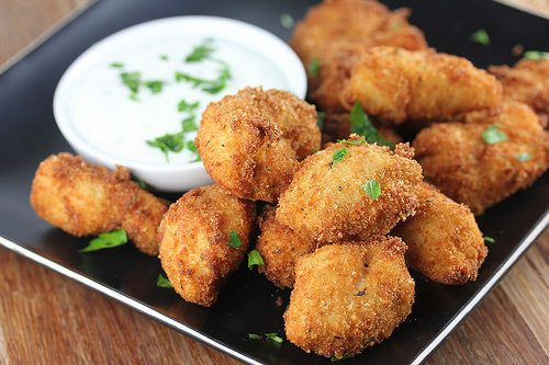 Crispy parmesan ranch chicken bites on a black plate