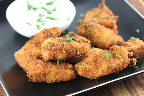 Breaded chicken bite dipped in creamy ranch sauce