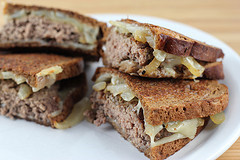 Patty melt sandwiches sliced on a plate