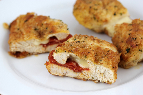 Sliced pepperoni stuffed chicken on plate