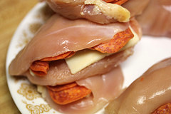 Raw chicken breasts stuffed with pepperoni and cheese