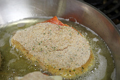 Breaded stuffed chicken cooking in hot oil