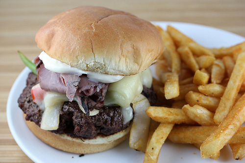 Cheesesteak burger with melted cheese and peppers