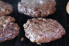 Sliced peppers and onions sautéing in a pan
