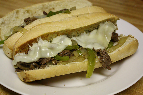 Close up of a cheesy Philly cheesesteak sandwich