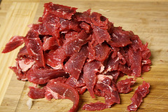Raw beef sliced on a cutting board