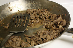 Sliced beef cooking in a skillet