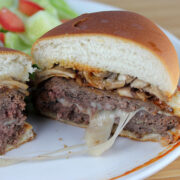 Pizza burger sliced open showing melted cheese