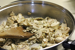 Sautéed mushrooms cooking in a skillet