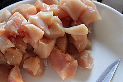 Raw diced chicken pieces in bowl
