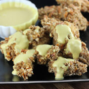 Crunchy pretzel chicken bites on black plate
