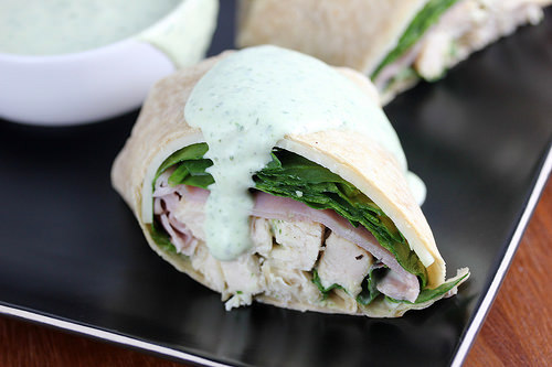 Chicken wrap with sliced chicken, ham, and greens