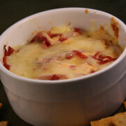 Creamy baked Reuben dip in a white ramekin with crackers