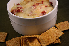 Hot cheesy Reuben dip served with square crackers