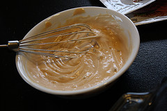 Smooth creamy sauce whisked in a white bowl