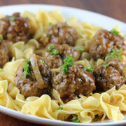 Close-up of salisbury steak meatballs on buttered egg noodles