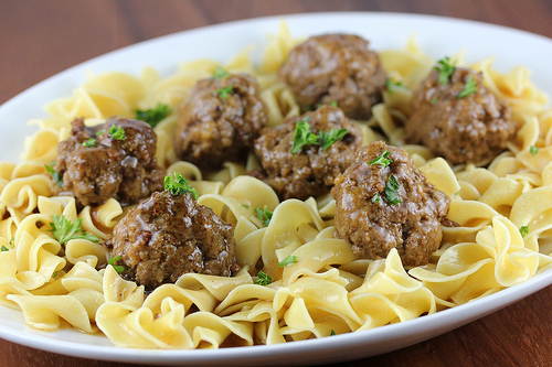 Salisbury steak meatballs served over egg noodles with gravy