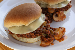 Two cheesy sloppy joe sandwiches on plate