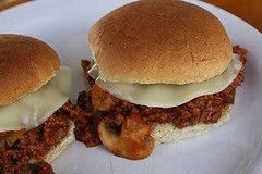 Sloppy joe sandwich with melted cheese on bun