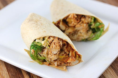 Shredded Mexican chicken wrap on white plate
