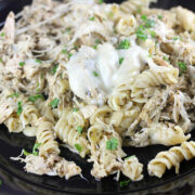 Creamy mozzarella chicken pasta in black plate