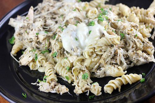 Creamy mozzarella chicken pasta in black plate