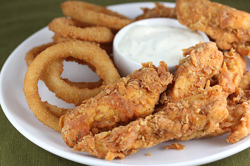 Fried chicken tenders with onion rings and dip