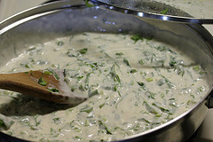 Creamy gorgonzola sauce with herbs in skillet