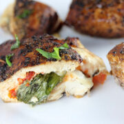 Seared stuffed chicken pieces on white plate