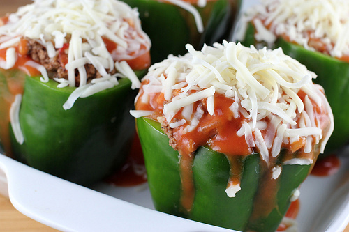 Close up of stuffed green peppers with melted cheese