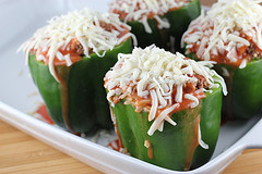 Stuffed green peppers arranged in baking dish