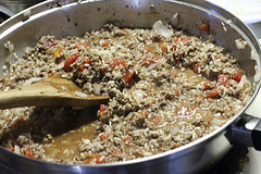 Ground beef and rice filling cooking in skillet