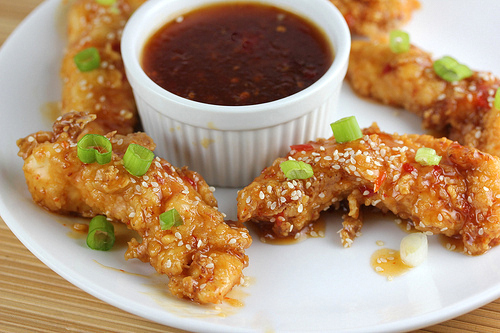 Sweet chili chicken strips on white plate