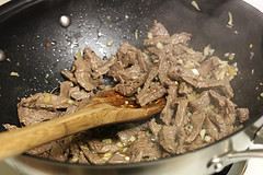 Beef strips cooking in wok