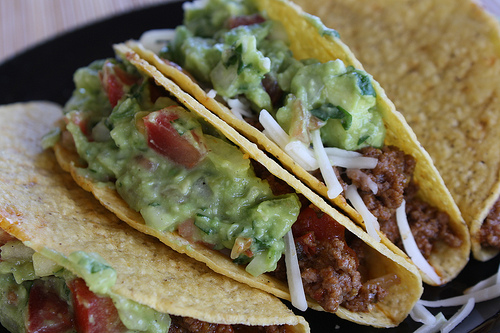 Close up of tacos with guacamole and cheese
