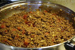 Seasoned taco meat cooking in skillet
