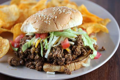 Taco joe sandwich topped with lettuce and tomato