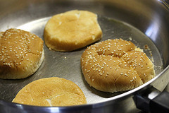 Burger buns toasting in pan