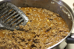 Seasoned taco meat cooking in skillet