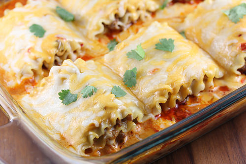 Taco lasagna roll ups baked in glass dish