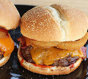 Bacon cheeseburgers arranged on plate