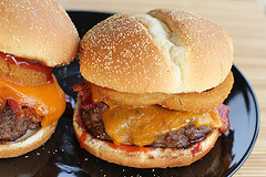 Bacon cheeseburgers arranged on plate